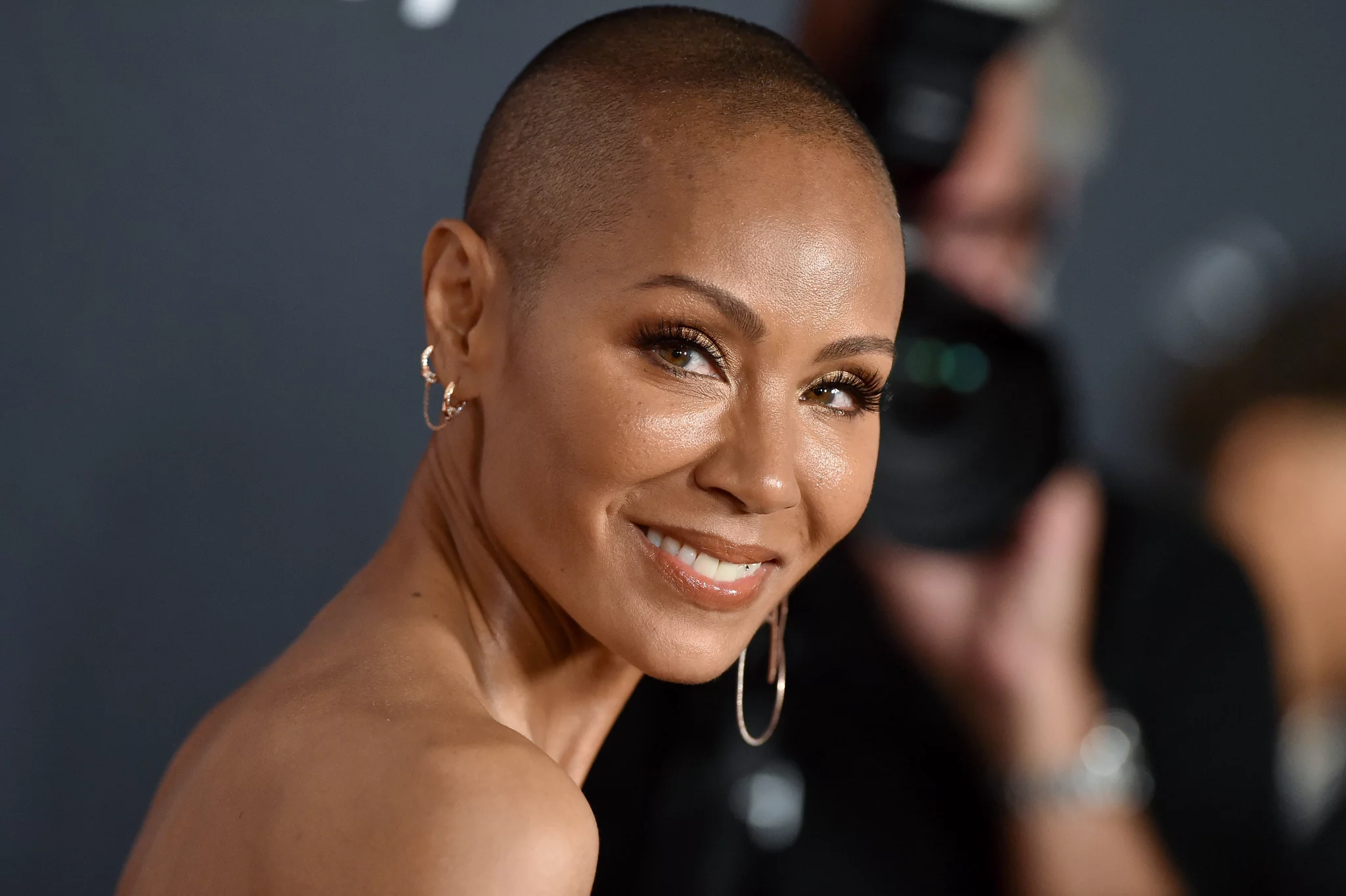 Six months after Chris Rock’s Oscars joke, Jada Pinkett Smith observes “Bald Is Beautiful” Day.